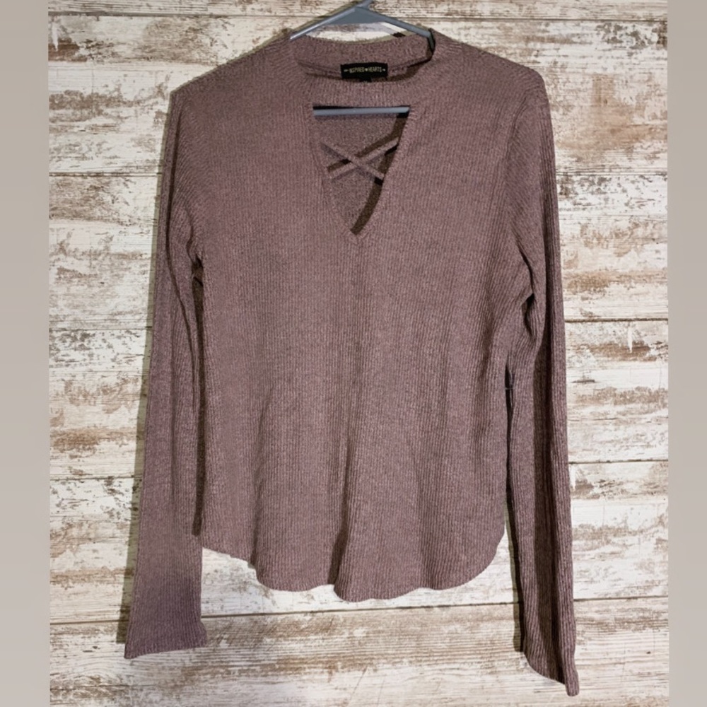 pink sweater with a crisscross v-neck